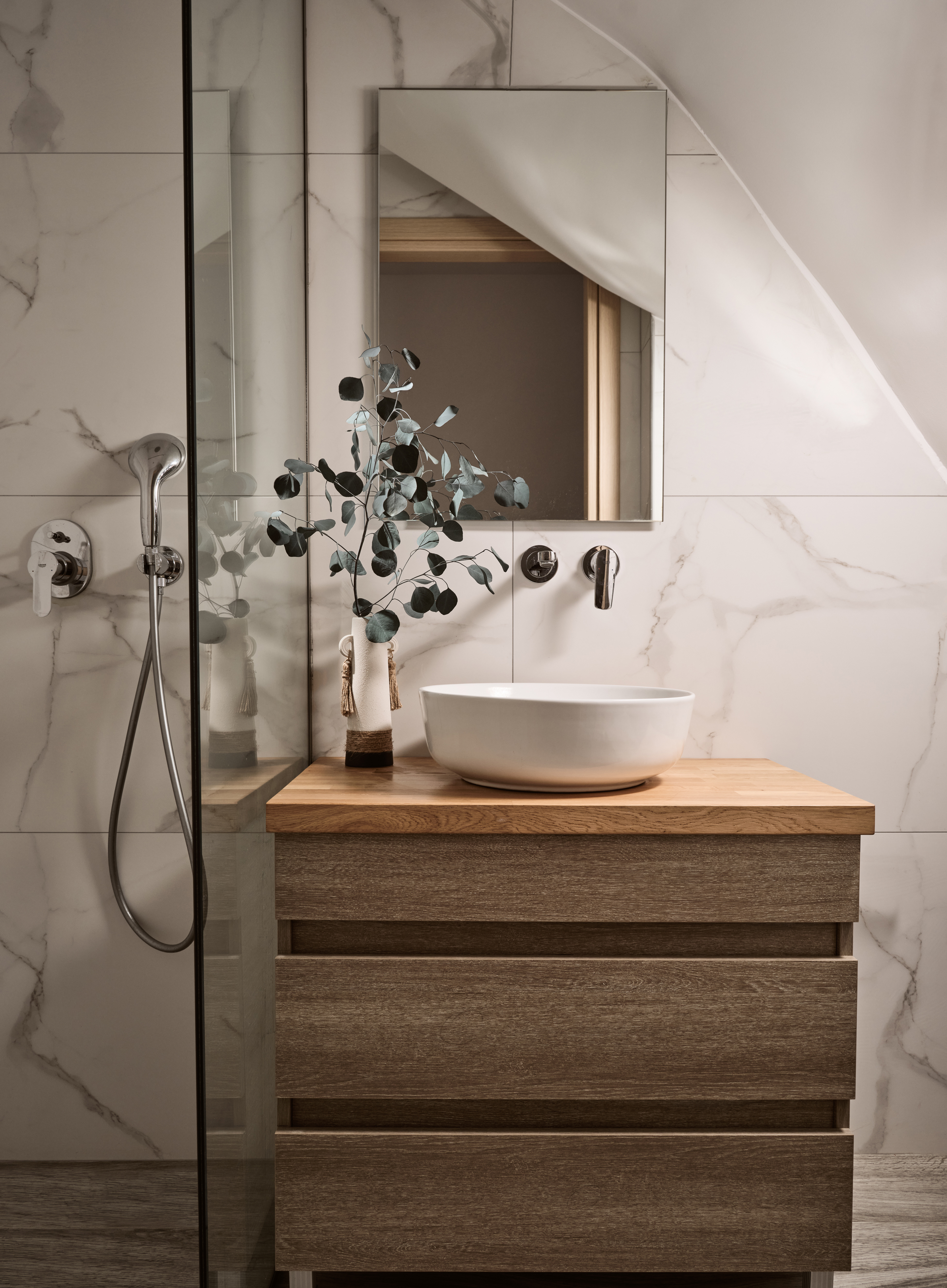 The bathroom features a walk in shower.